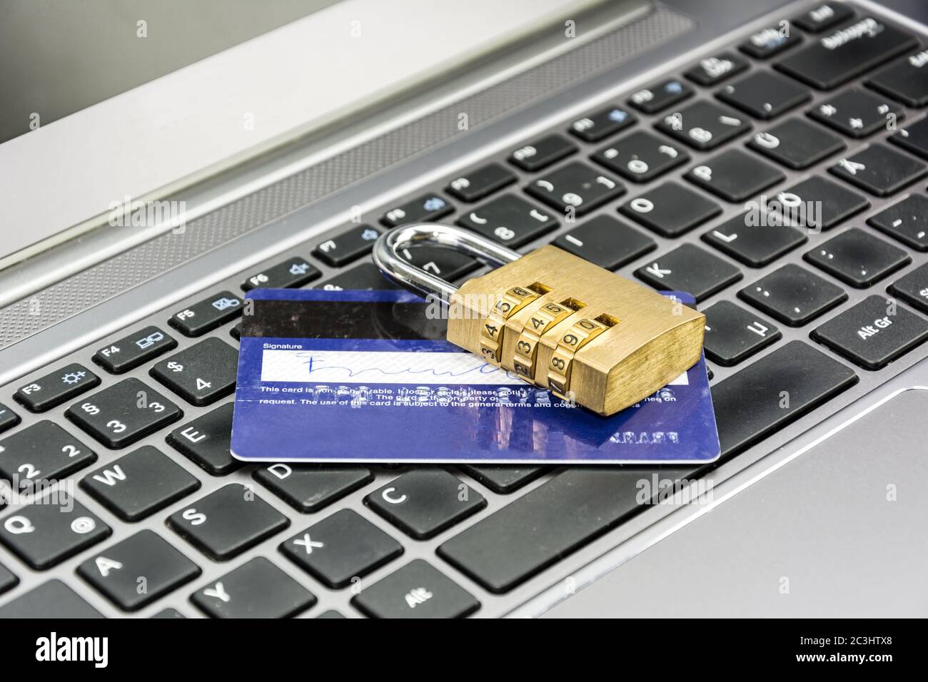 Credit card and padlock on computer keyboard symbolizing secure online payments Stock Photo