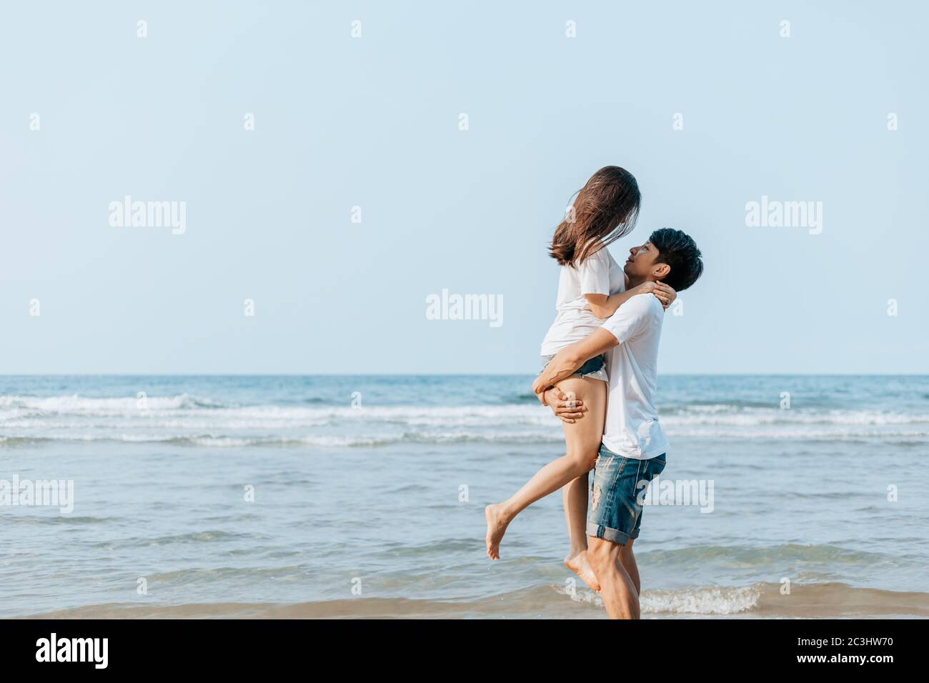 Romantic couple having love and hug on the beach Stock Photo - Alamy