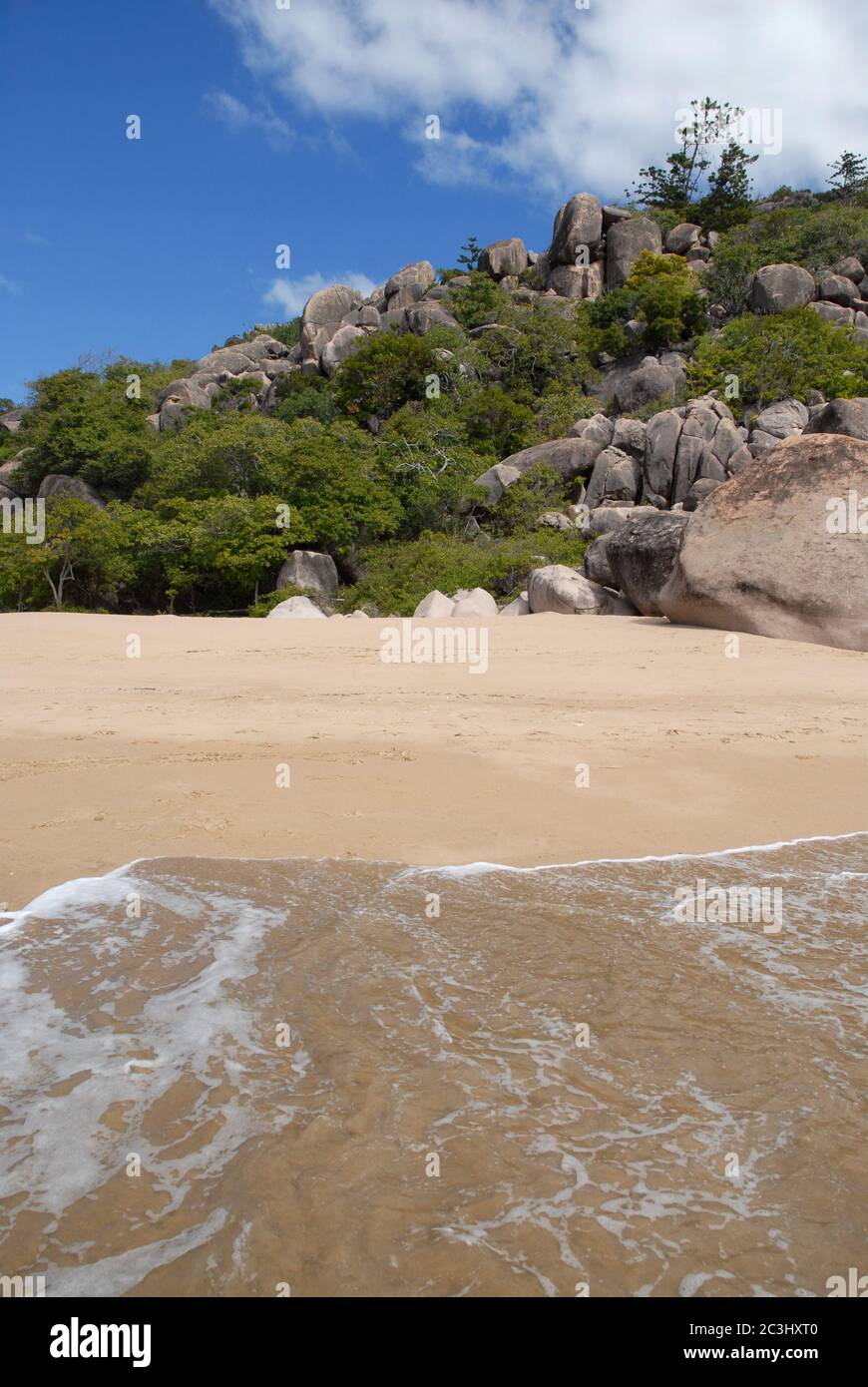 Sea to beach view with Hoop pines and granite boulders at Radical Bay, typical of Magnetic Island, Queensland, Australia Stock Photo