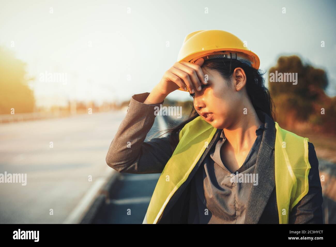 engineer women wipe sweat and hot weather at site construction. Stock Photo