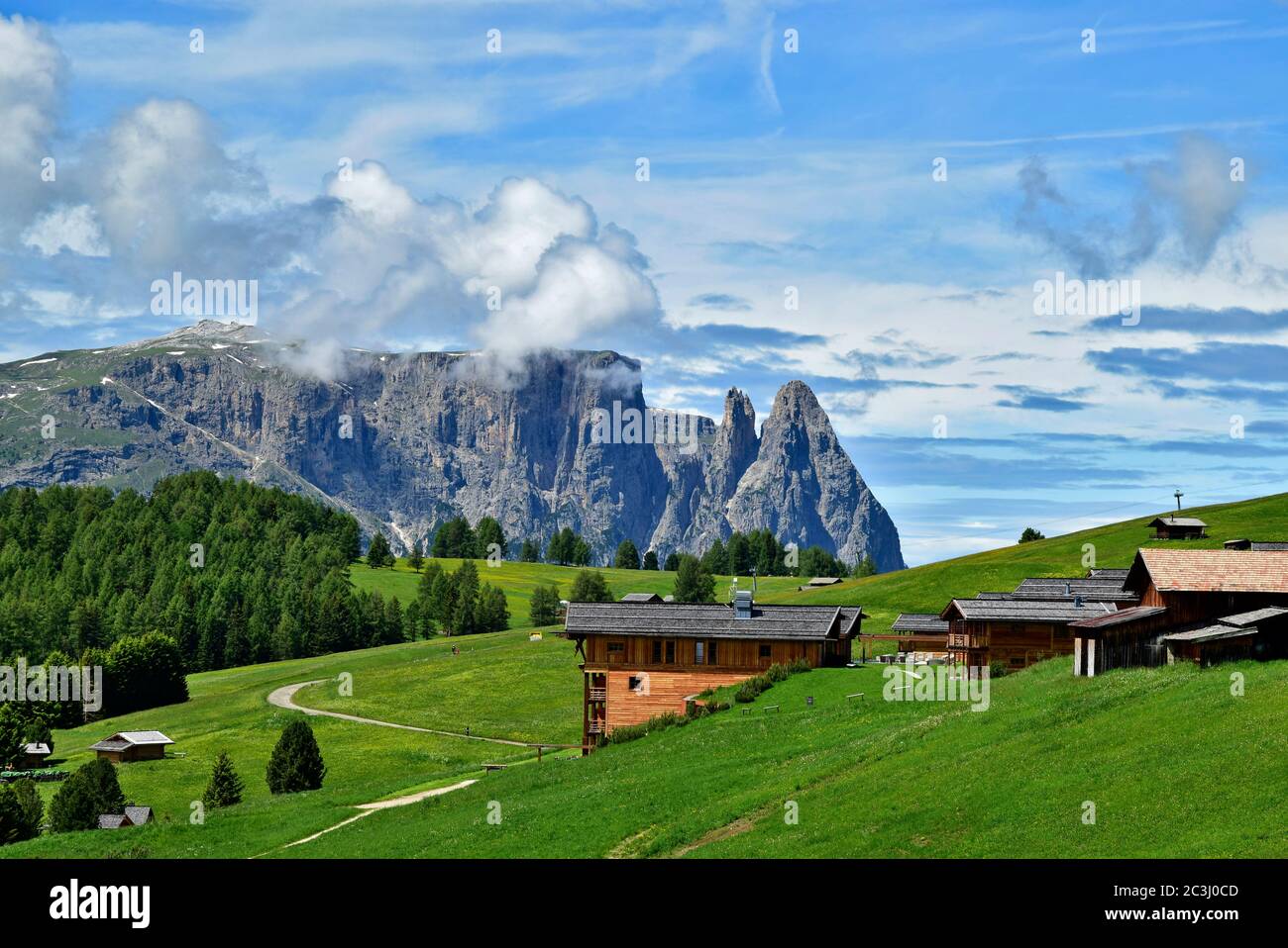 Small alpine hill village with rock mountain background on Alpe di Siusi, Dolomites, Italy Stock Photo