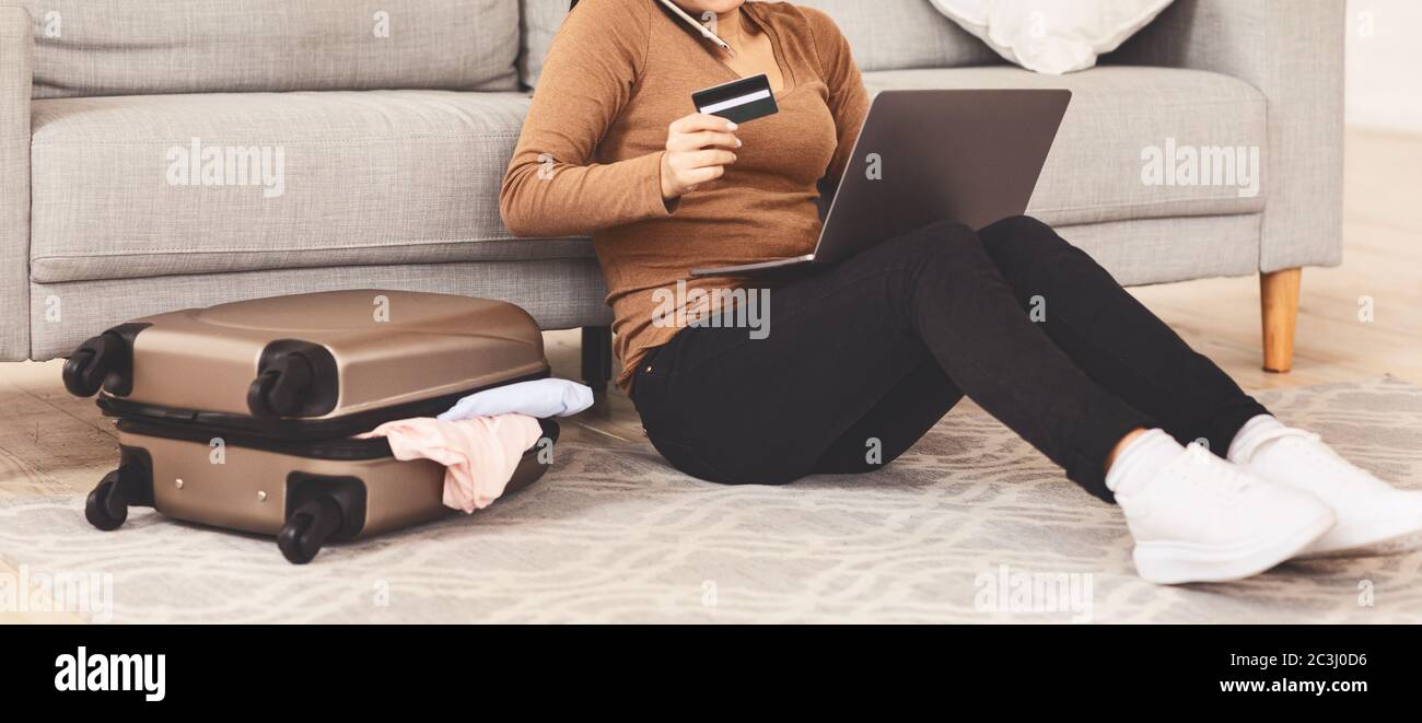 Unrecognizable Woman Talking On Phone Holding Credit Card At Home Stock Photo