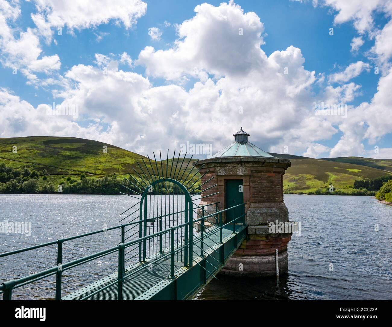 Lammermuir Hills, East Lothian, Scotland, United Kingdom, 20th June 2020. UK Weather: sunshine with puffy clouds on the longest day of the year at Hopes Reservoir with a view of the outlet tower Stock Photo