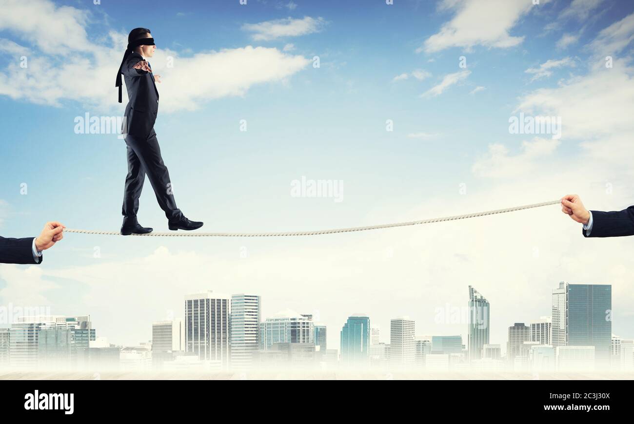 Business concept of risk support and assistance with man balancing on ...