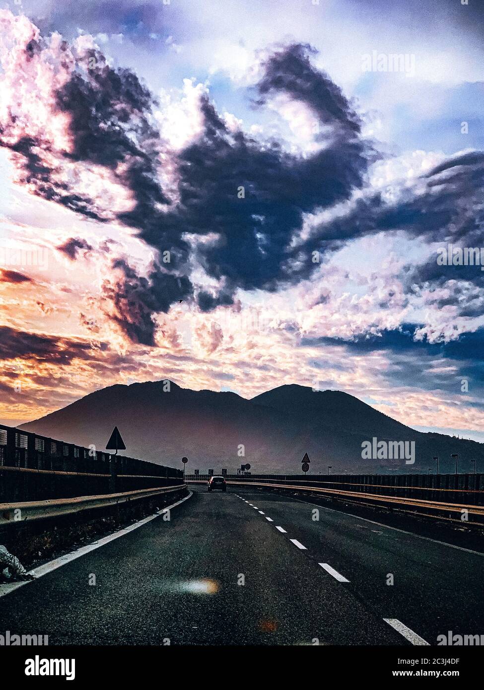 Vertical shot of a road under the dark sky Stock Photo - Alamy