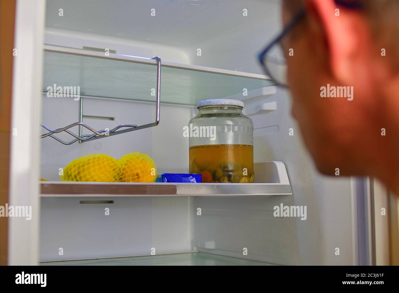Portrait of a hungry man looking for food in refrigerator. Man looking inside an empty refrigerator Stock Photo