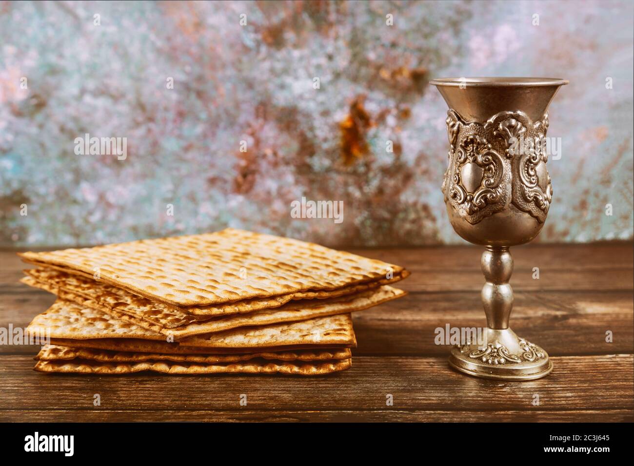 Matzos unleavened bread with kiddush cup of wine. Jewish pesah holiday. Stock Photo