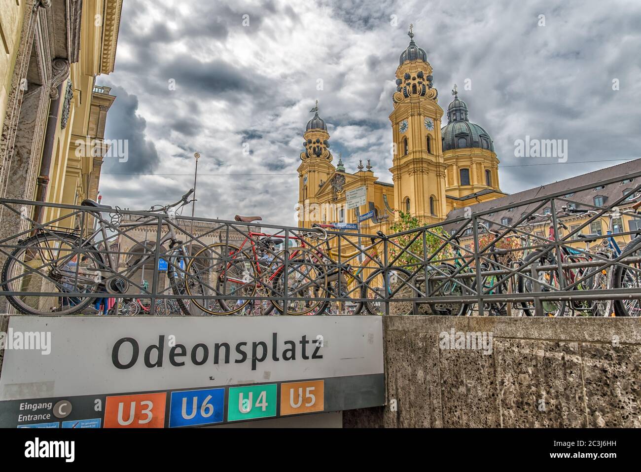 Bicycles at Odeonsplatz station overlooking the  Theatine Church of St. Cajetan (Theatinerkirche St. Kajetan) in Munich, Germany. Stock Photo