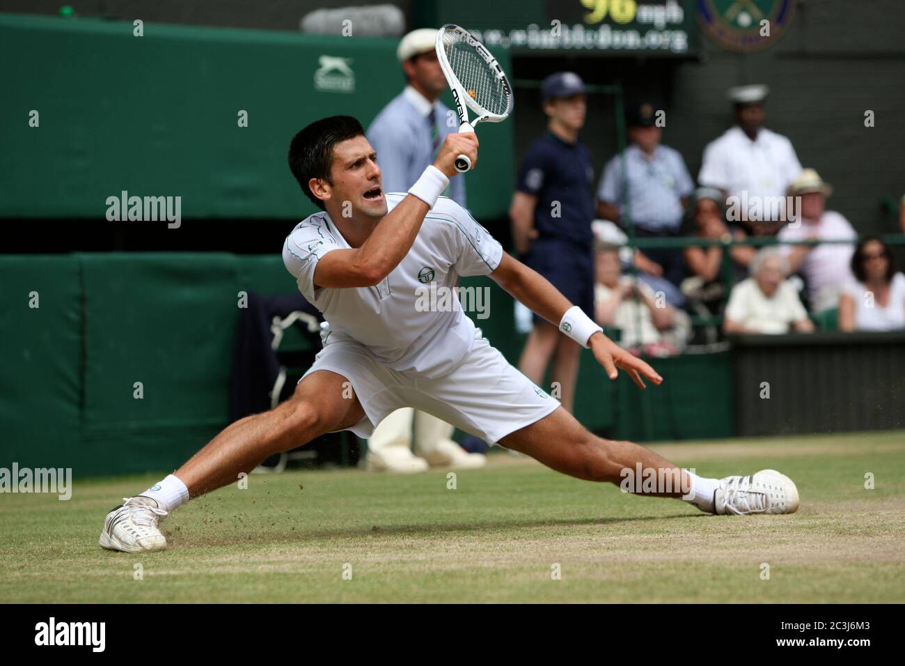 Novak Djokovic reaches wide for a forehand during his his semi-final match against Tomas Berdych at Wimbledon. Stock Photo