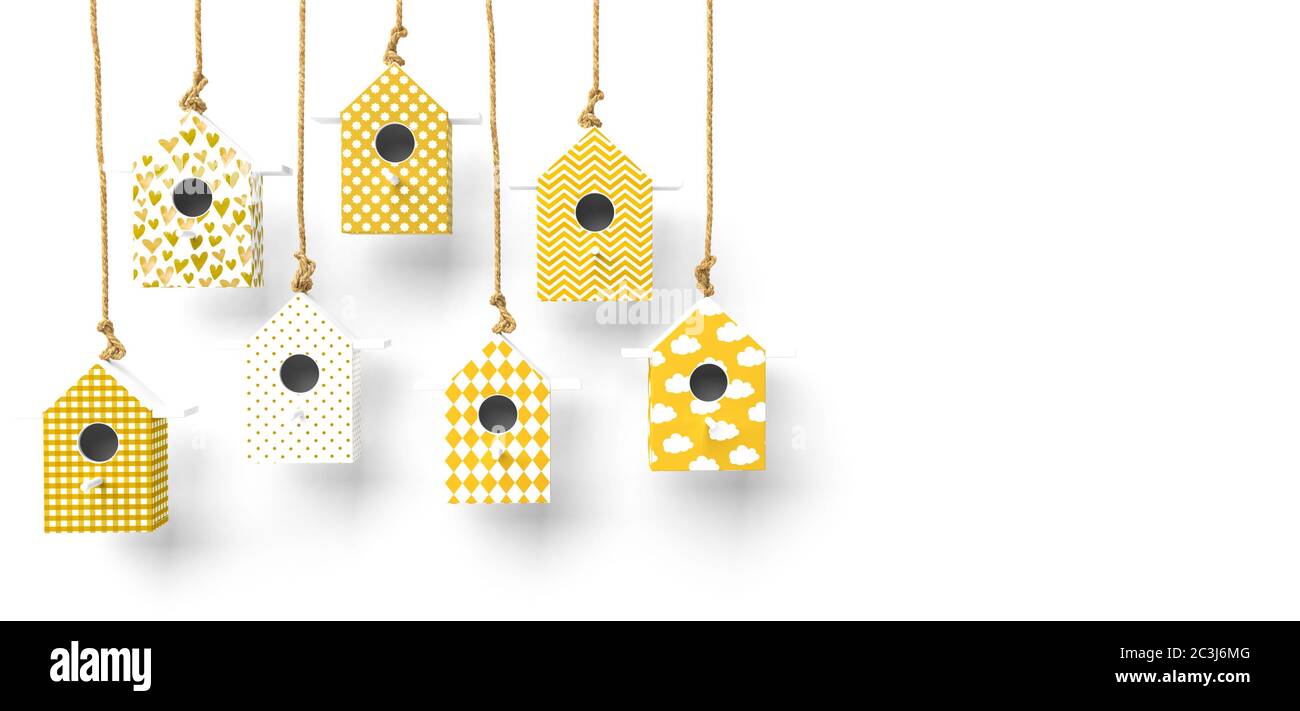 A set of painted birdhouses are suspended on a rope. Birdhouses with yellow and white patterns isolated on a white background with space for text. 3D Stock Photo