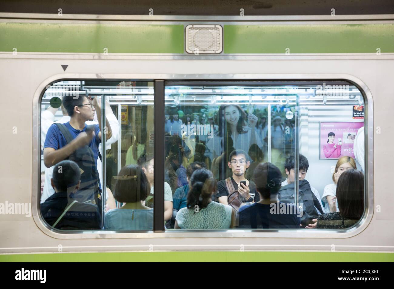 TOKYO, JAPAN - June 19 2016: Busy commuter  train at Shinjuko station. This is the busiest train station in the world and 3.4 million people pass thro Stock Photo