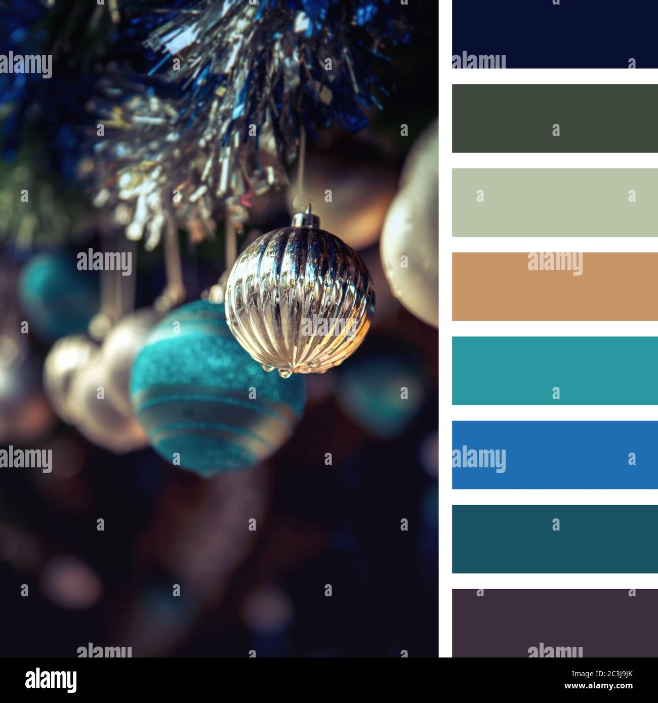 A garland of antique style Christmas tree baubles hanging from tinsel