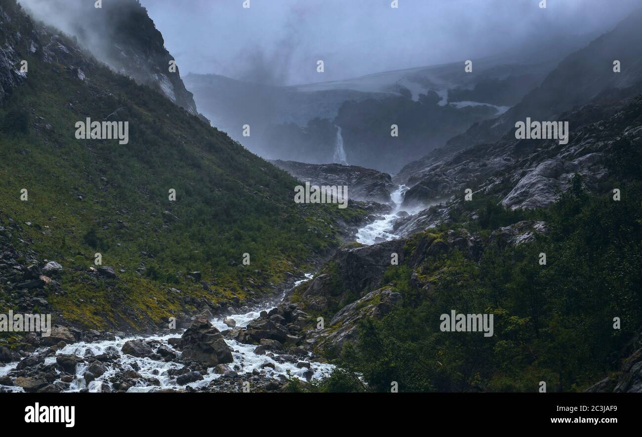 Dramatic Moody View of the River coming from Buerbreen Glacier Down the Valley, Odda, Norway Stock Photo