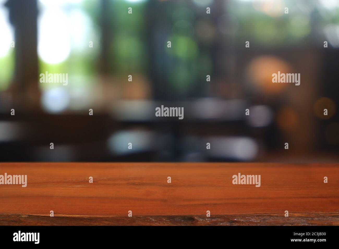 Empty wooden table in front of abstract blurred Cafe, restaurant. For ...