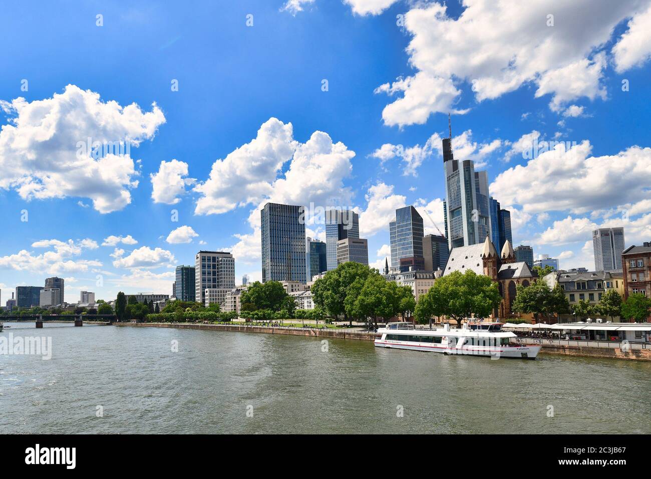 Frankfurt am Main, Germany - June 2020:  Main river and view on tall skyscrapers of financial district of modern Frankfurt city center Stock Photo