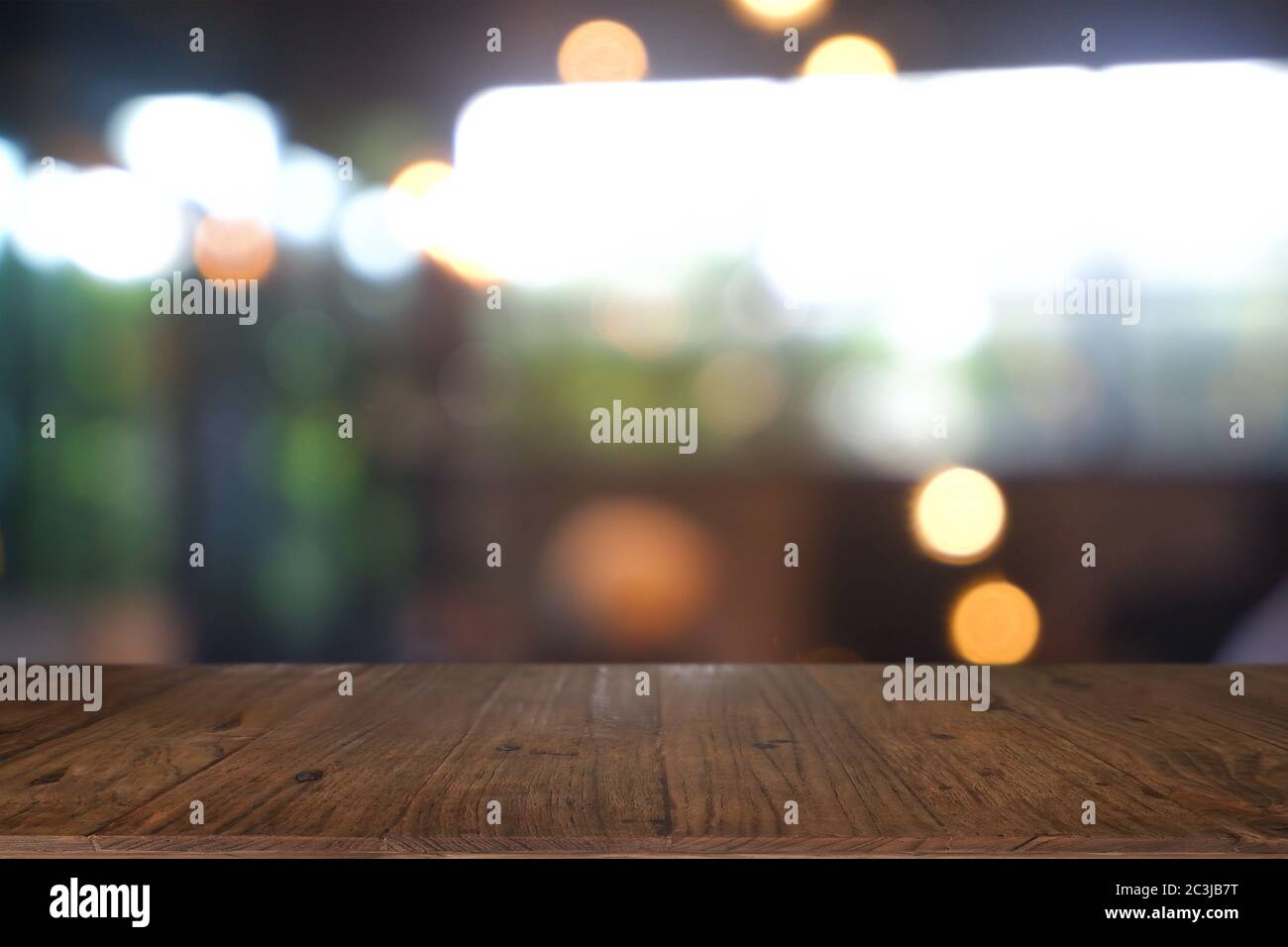 Empty wooden table in front of abstract blurred Cafe, restaurant. For ...