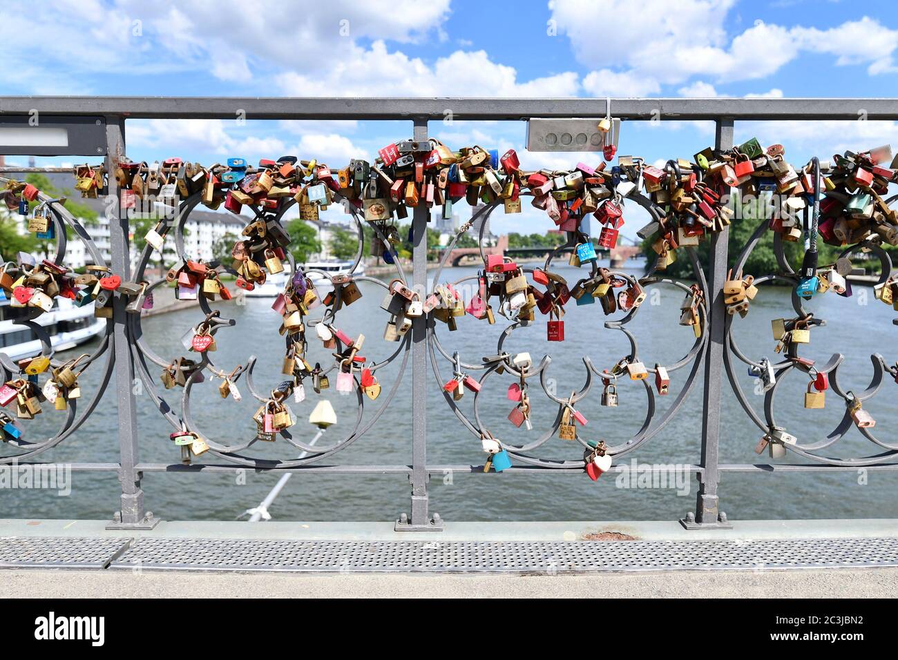 Bridge railing full of love padlocks at bridge called 'Eiserner Steg' in Frankfurt city in Germany Stock Photo