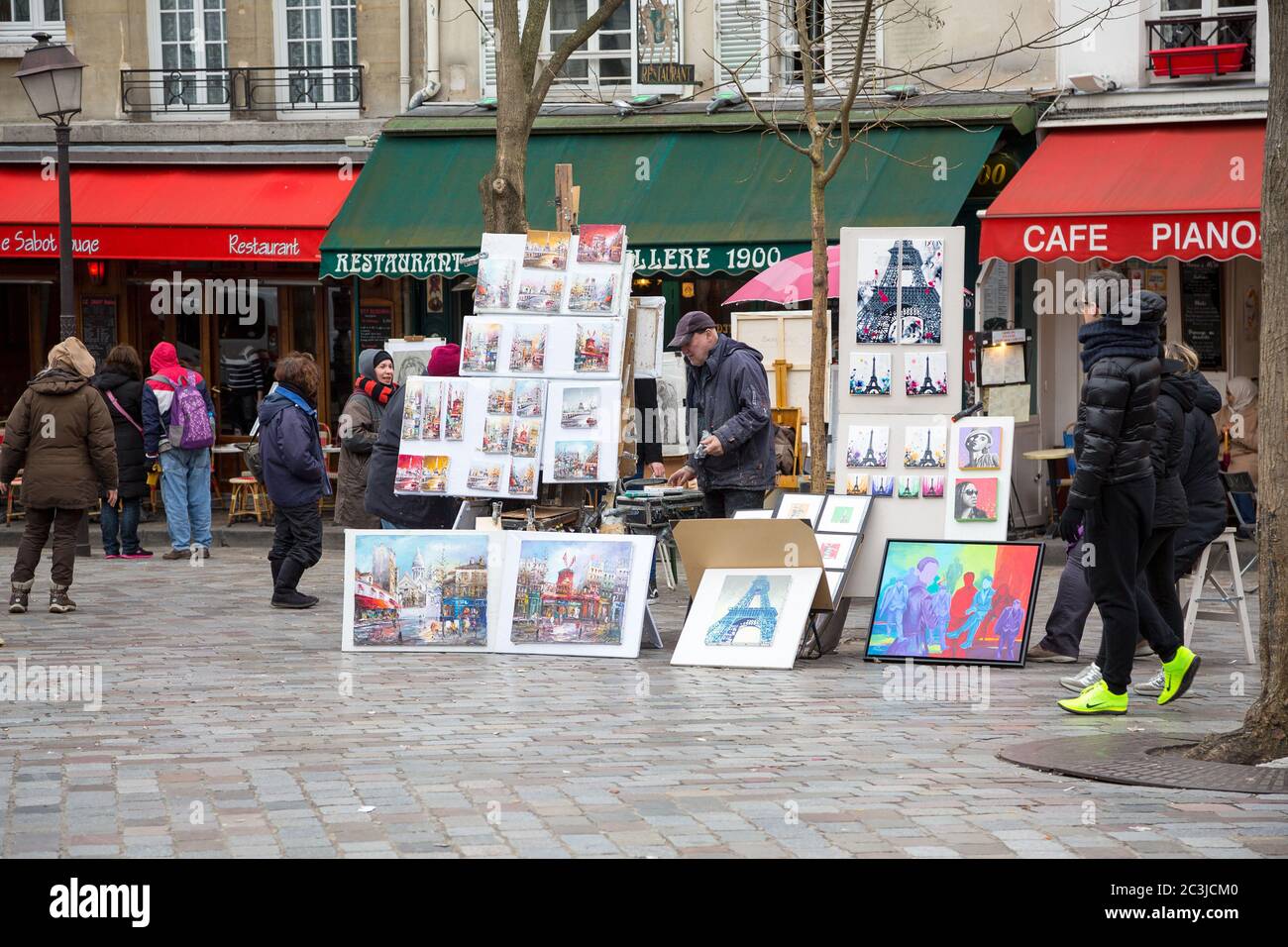 PARIS, FRANCE - MARCH 3RD: Street artists display their work in a cobbled market square in Montmartre, 18th Arrondissement. On March 3rd 2015 Stock Photo