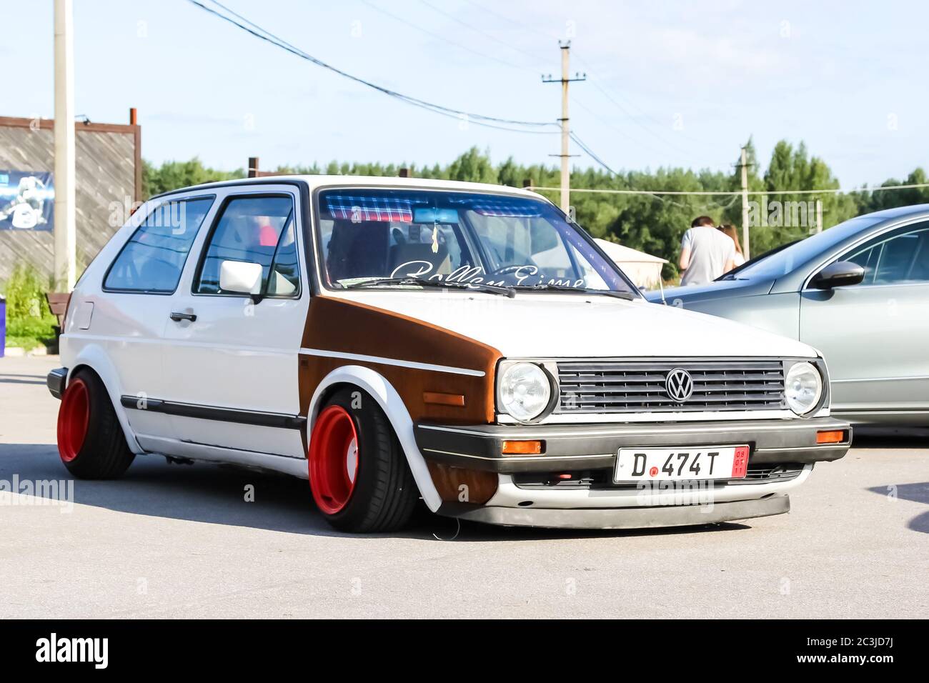 Moscow. Russia - May 20, 2019: White tuned in Stance style Volkswagen Golf mk 1. Low car with wide red wheels parked on the street. Cult and legendary Stock Photo