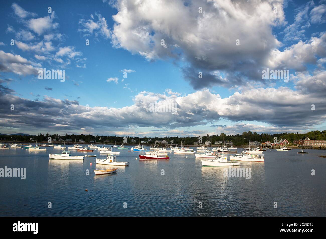 Dramatic cloud formations over small fishing and lobster boats in
