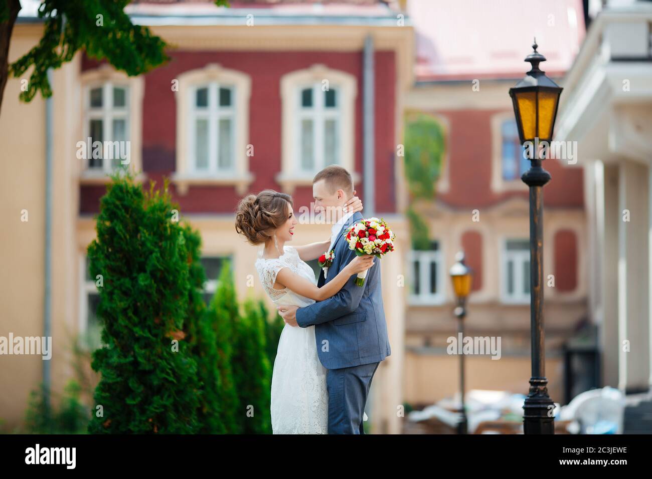 Wedding couple, happy newlyweds and husband hugging in green park Stock ...