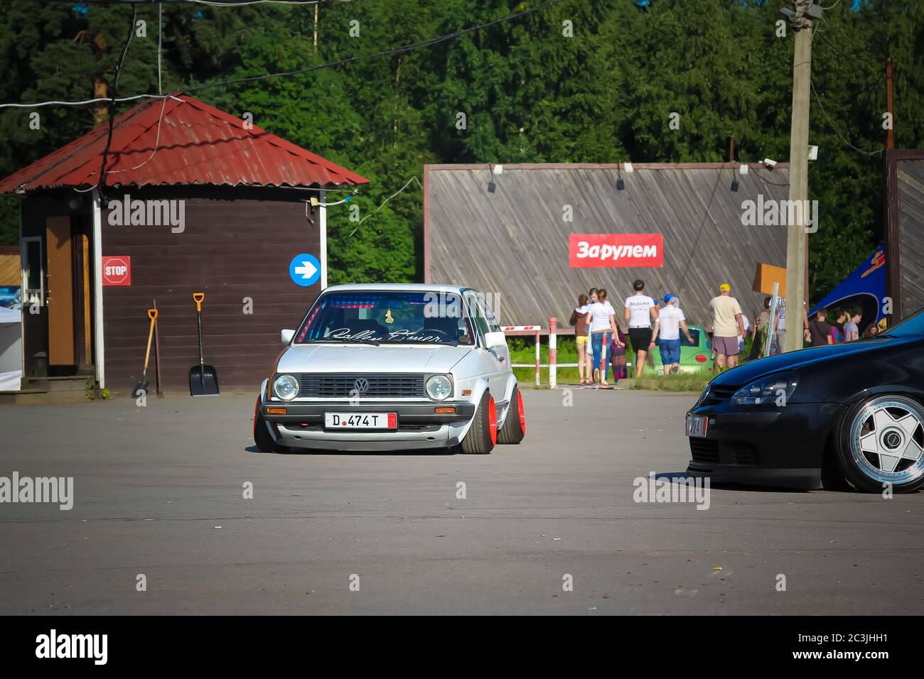 Moscow. Russia - May 20, 2019: White tuned in Stance style Volkswagen Golf mk 1. Low car with wide red wheels parked on the street. Cult and legendary Stock Photo