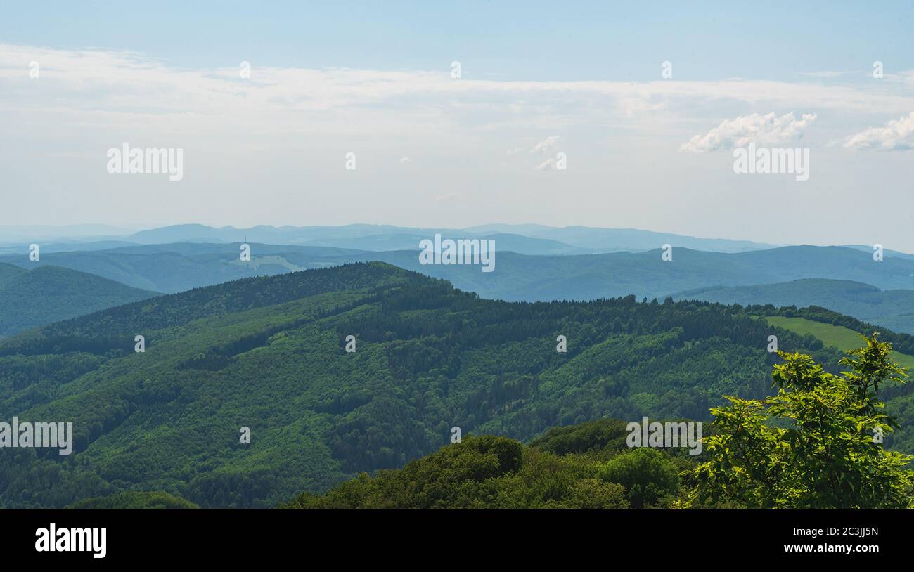 View from Chmelova hill above Vrsatske Podhradie village in Biele Karpaty mountains in Slovakia during springtime day Stock Photo