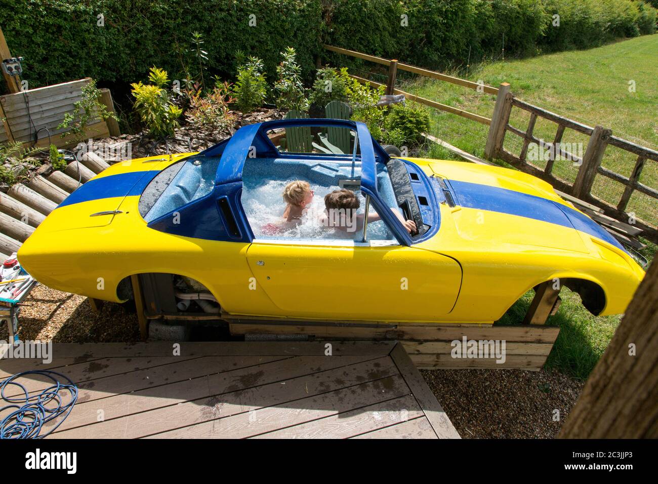 Testing a Lotus Elan +2 classic car being converted into a custom hot tub (unfinished), Medstead, Alton, Hampshire England, United Kingdom. Stock Photo