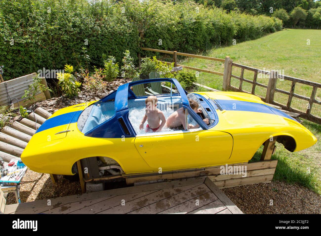 Testing a Lotus Elan +2 classic car being converted into a custom hot tub (unfinished), Medstead, Alton, Hampshire England, United Kingdom. Stock Photo