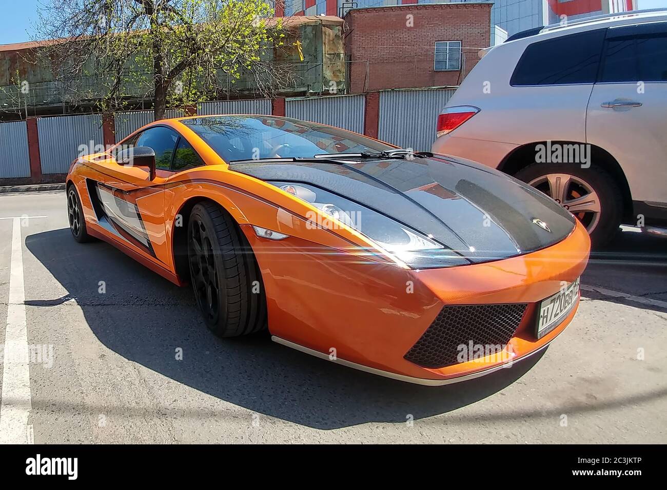 Moscow, Russia - April 14, 2019: bright orange Lamborghini Gallardo with carbon hood and other parts parked on the street Stock Photo