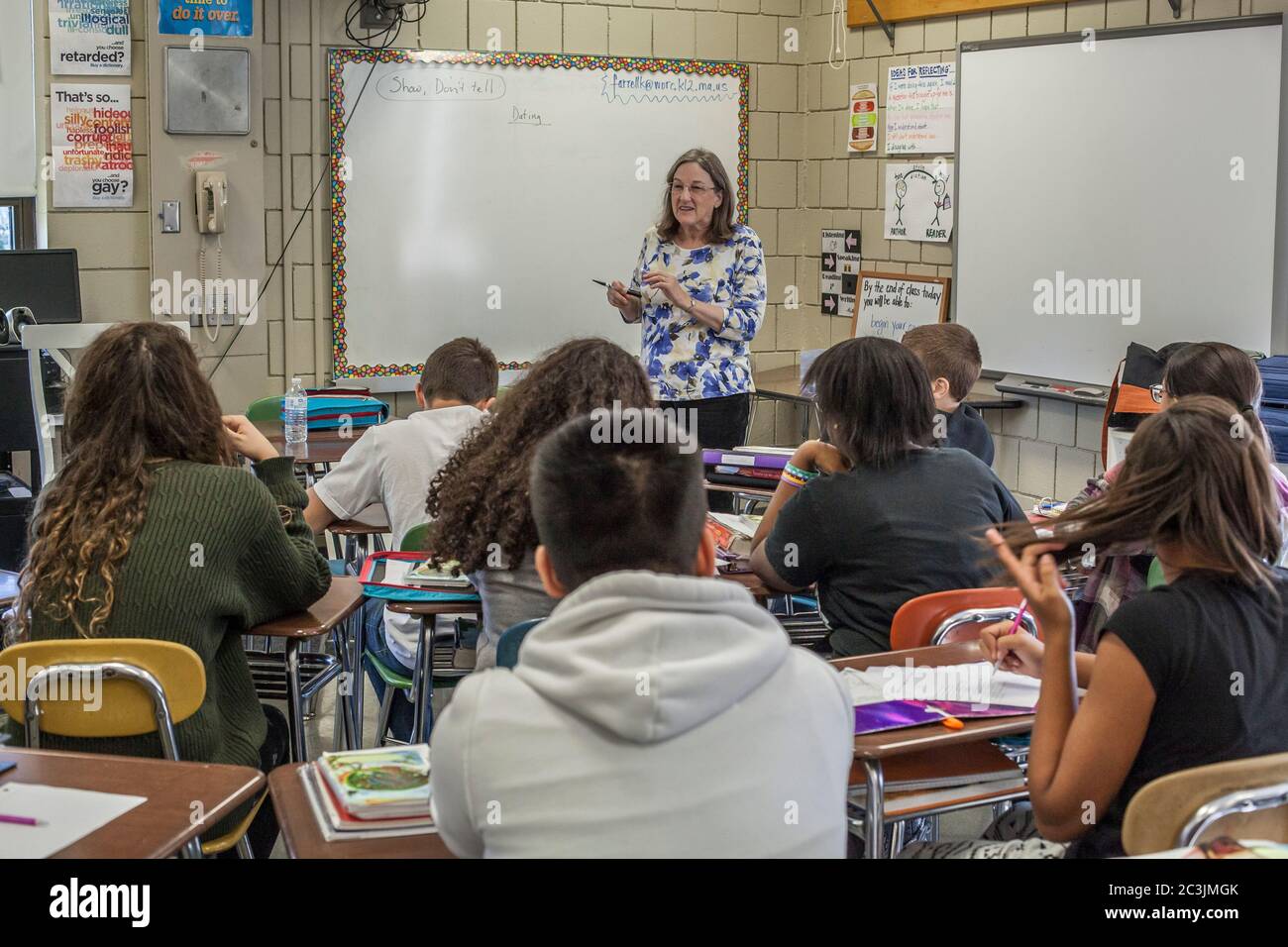 A teacher instructing students in an English class Stock Photo