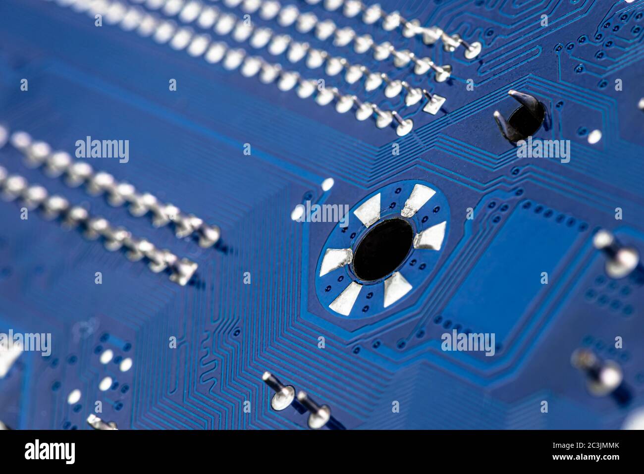 Macro photo of electrical paths on blue circuit board, visible soldering of  the semiconductor tip and a screw attachment hole Stock Photo - Alamy