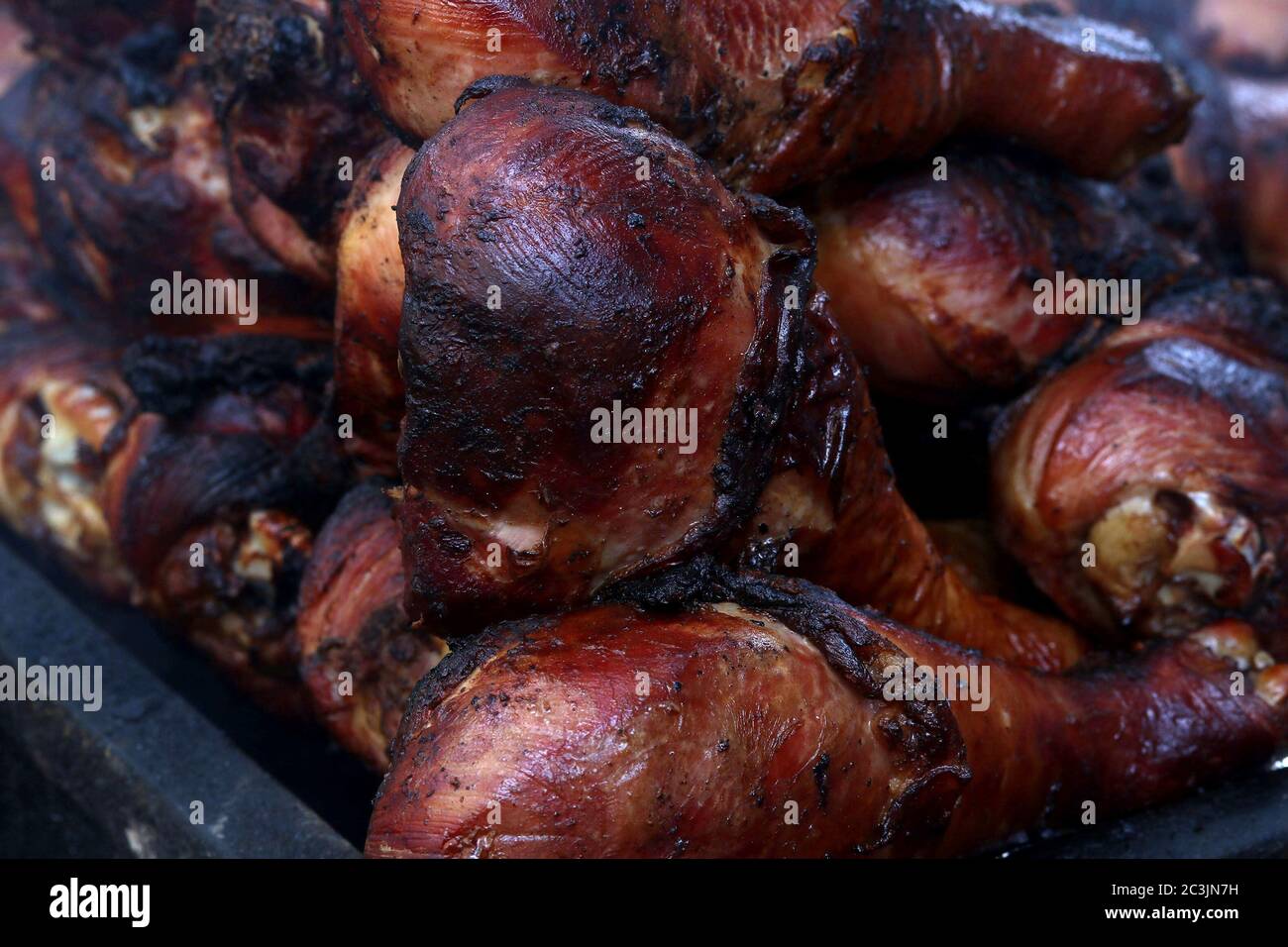 Barbecued turkey drumsticks on a grill at street fair Stock Photo