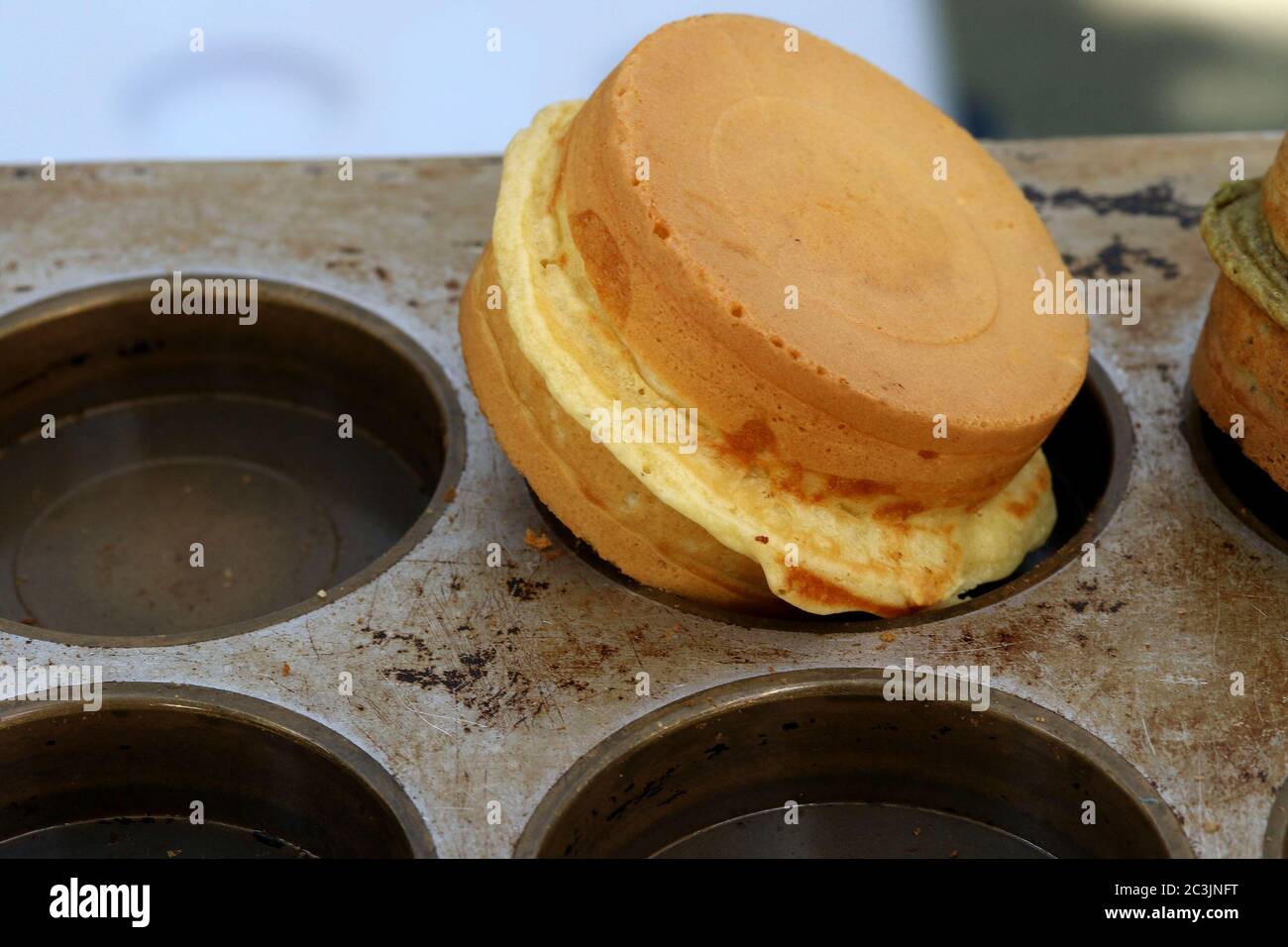 Corn muffin with melted cheese in a baking tin Stock Photo