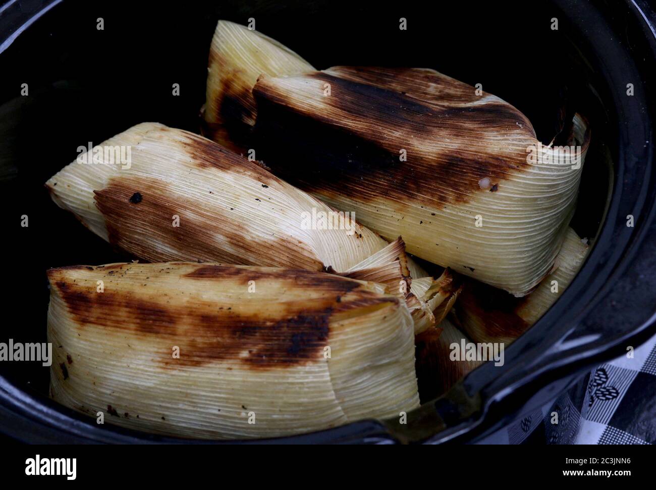Three cooked tamales seen at a street fair Stock Photo