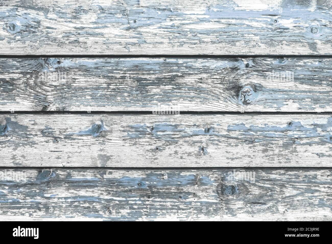 Color-Peel wood texture. Battered faded old light blue painted wooden boards with peeling. Wooden abstract background, texture. Stock Photo