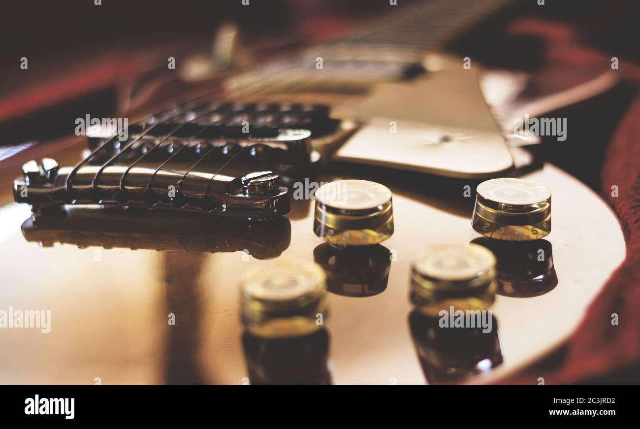 Closeup of an electric guitar laying inside a guitar case. Retro style