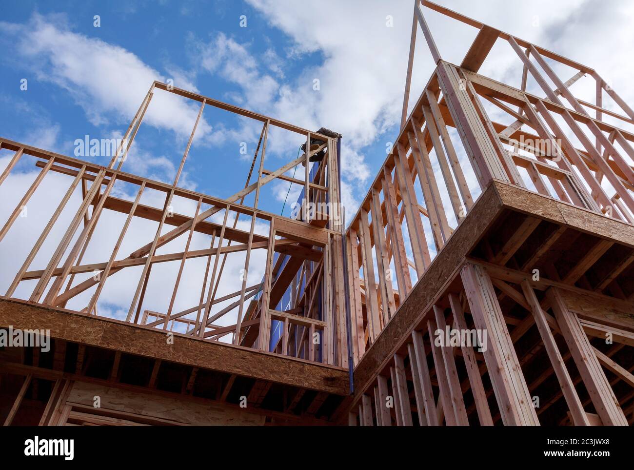 Residential construction home framing under construction wooden truss, post beam framework frame house Stock Photo