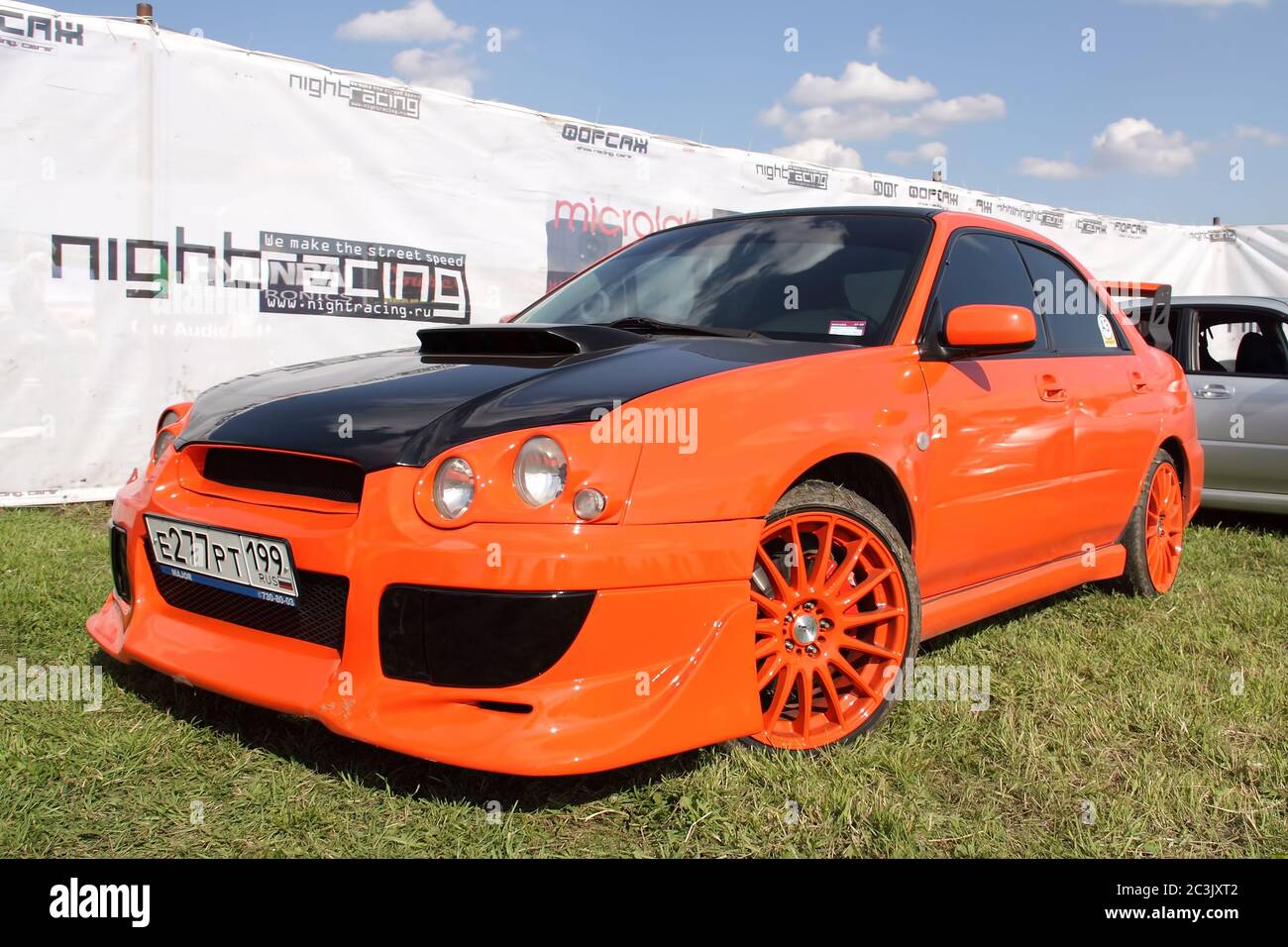 Moscow, Russia - May 25, 2019: A bright orange Subaru WRX STI tuned in a  body kit with orange alloy wheels stands on the street Stock Photo - Alamy