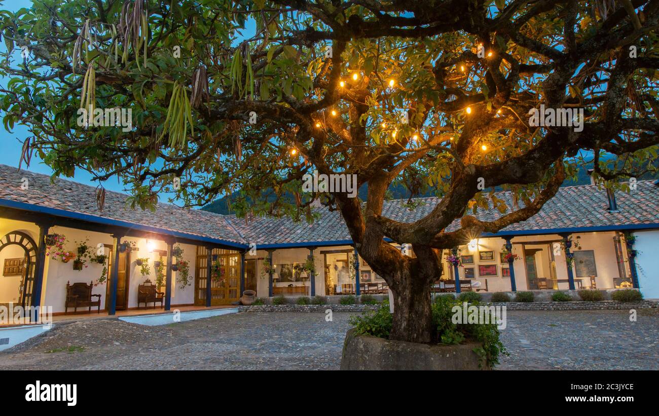 Zuleta Imbabura Ecuador November 9 2018 View Of An Interior Courtyard Of An Old Country House With Yellow Lights Lit With A Tree In The Middle A Stock Photo Alamy
