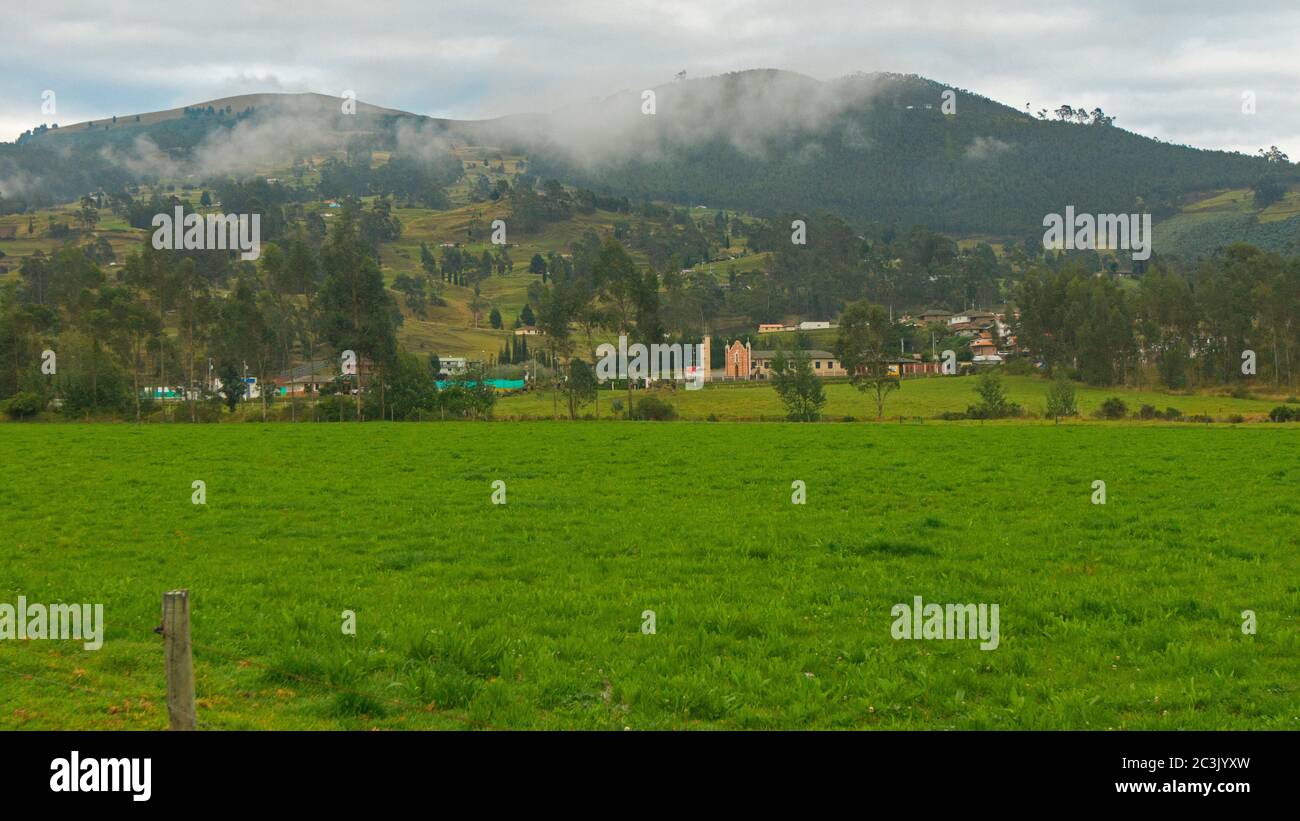 Zuleta, Imbabura / Ecuador - November 9 2018: View of the village of Zuleta with background of mountains with trees on a cloudy day from a field with Stock Photo