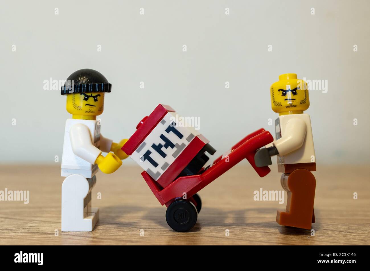 POZNAN, POLAND - May 01, 2020: Two Lego prisoners transporting TNT explosives with a red cart. Stock Photo