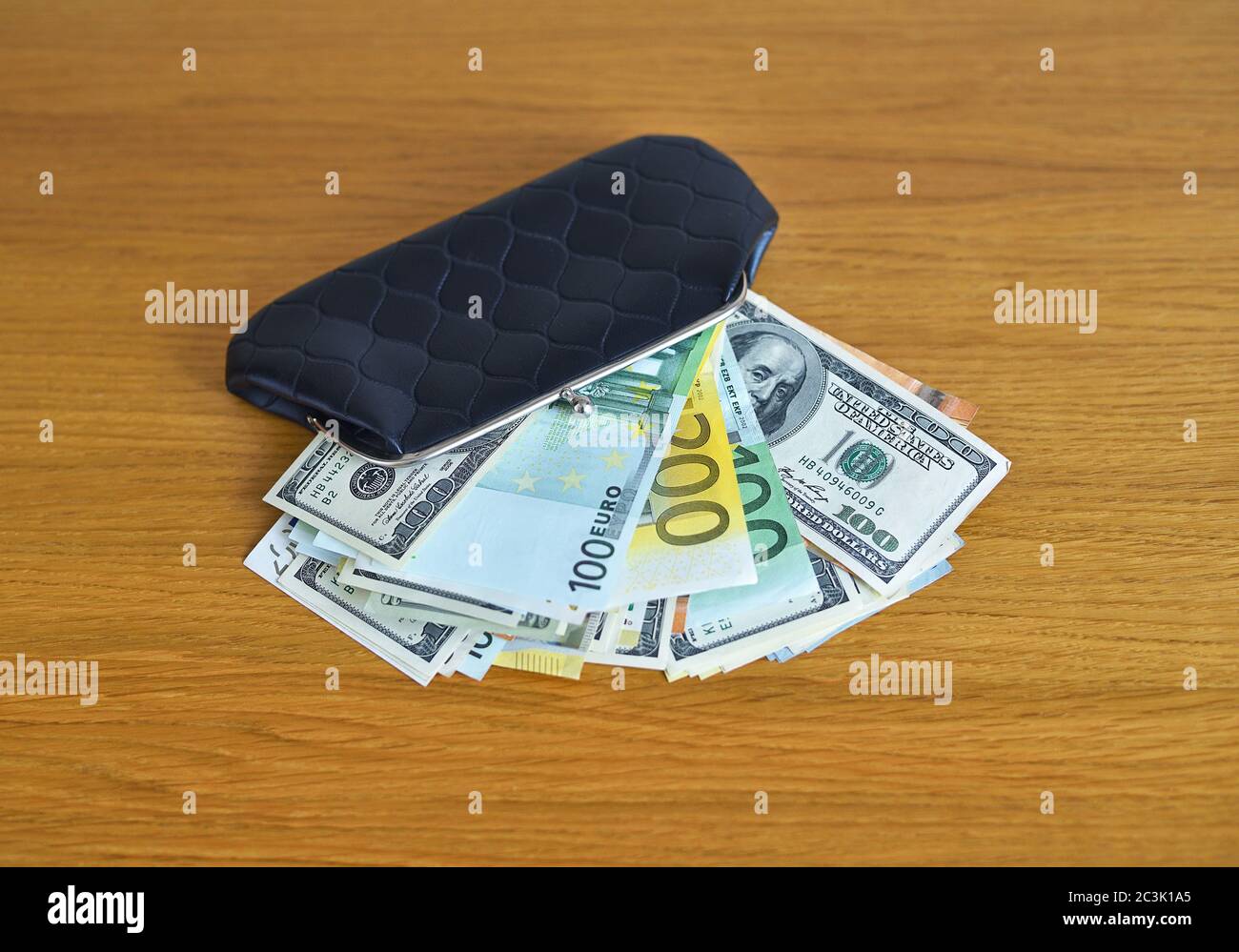 Euro and dollars money with black wallet on the table Stock Photo