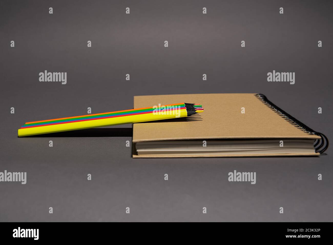 closed notebook with craft cover and spiral mount lies on gray ...