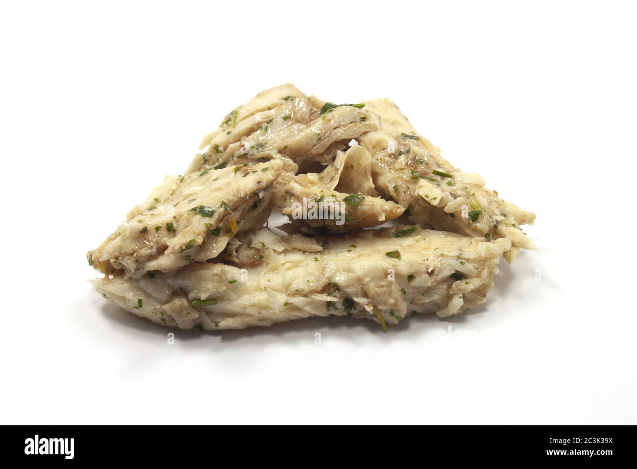 Closeup shot of San Pietro fish in green sauce on a white isolated