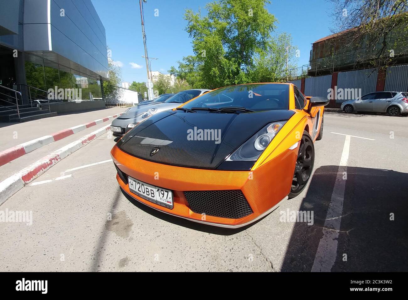 Moscow, Russia - April 14, 2019: bright orange Lamborghini Gallardo with carbon hood and other parts parked on the street Front view Stock Photo