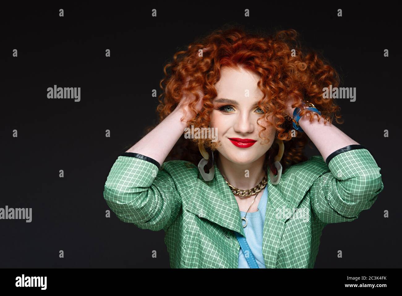 girl with red curly hair smiles, happy man, red lipstick on lips, stylish image Stock Photo