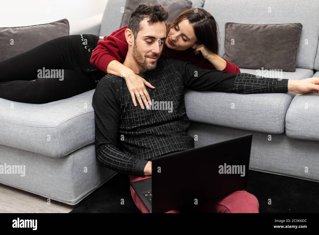 Couple Using One Computer Portrait of an happy couple using a laptop computer in their house ...