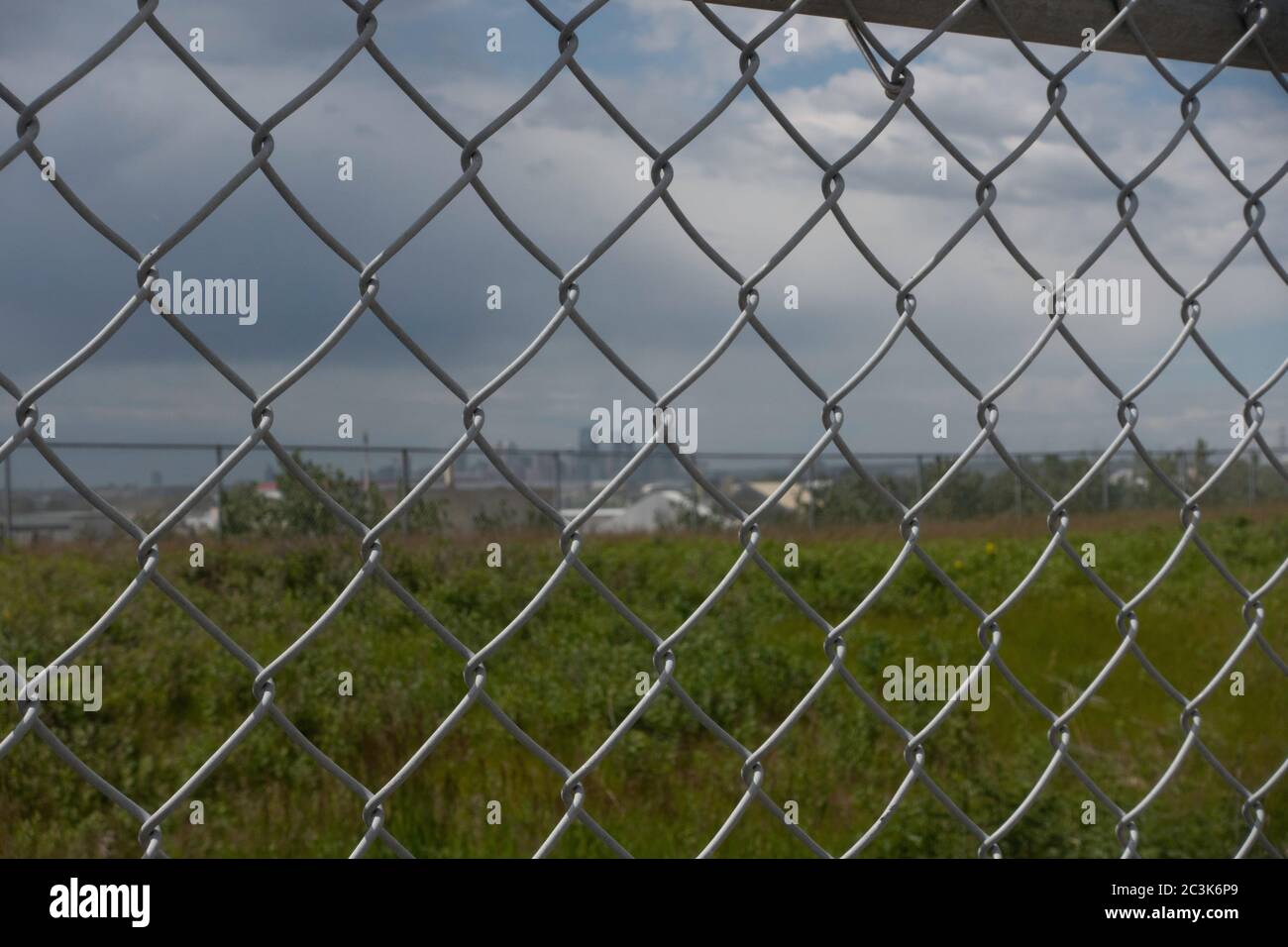 Chain Link Mesh Fence with calgary skyline in distance Stock Photo Alamy