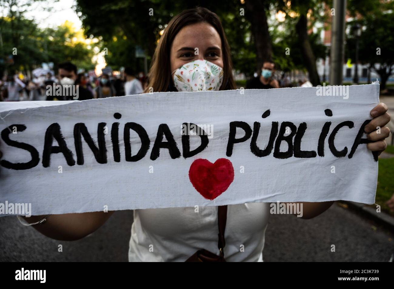 Madrid, Spain. 20th June, 2020. Madrid, Spain. June 20, 2020. A woman with a banner reading 'Public Healthcare' during a demonstration in support of the public healthcare system and protesting against privatization. Healthcare workers are carrying out protests during the coronavirus crisis against the precariousness of their work. Credit: Marcos del Mazo/Alamy Live News Stock Photo